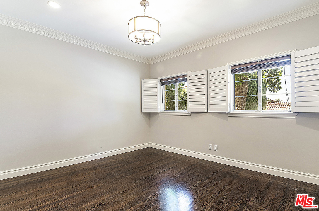 9601 Charleville Boulevard, Unit 8 Beverly Hills, CA 90212 - Photo 33 of 47 a view of a room with wooden floor and windows