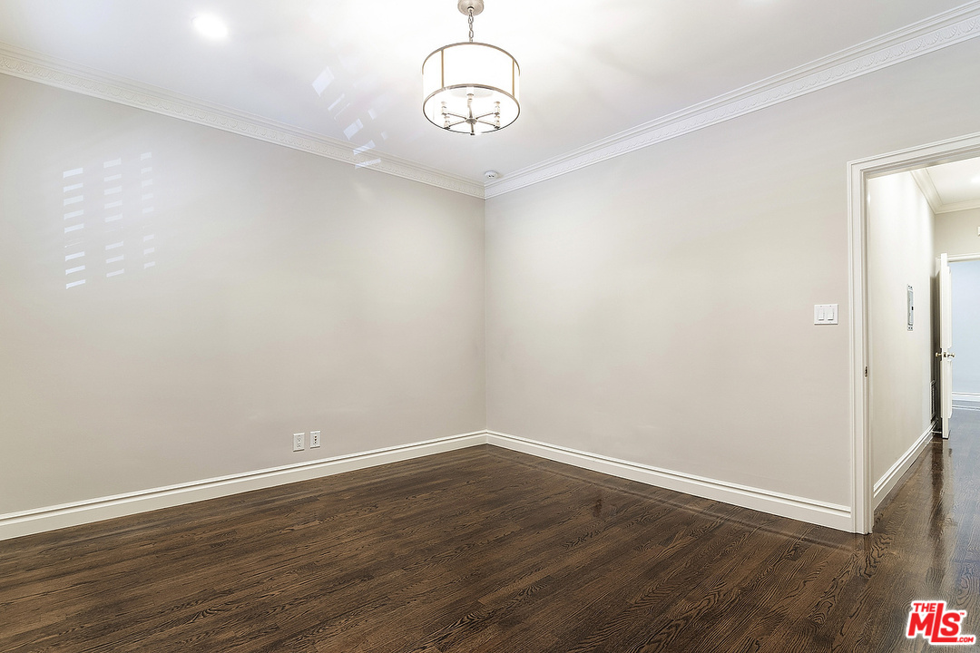 9601 Charleville Boulevard, Unit 8 Beverly Hills, CA 90212 - Photo 34 of 47 a view of a room with wooden floor and white walls