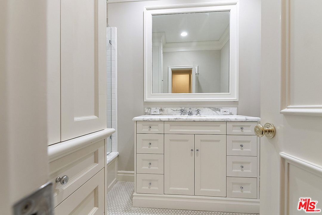 9601 Charleville Boulevard, Unit 8 Beverly Hills, CA 90212 - Photo 37 of 47 a bathroom with a sink vanity and a mirror