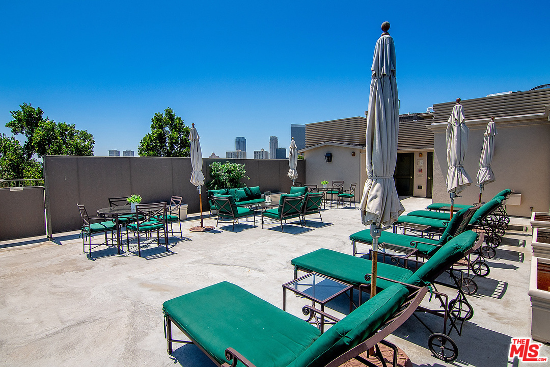 9601 Charleville Boulevard, Unit 8 Beverly Hills, CA 90212 - Photo 44 of 47 a view of a patio with couches table and chairs with potted plants