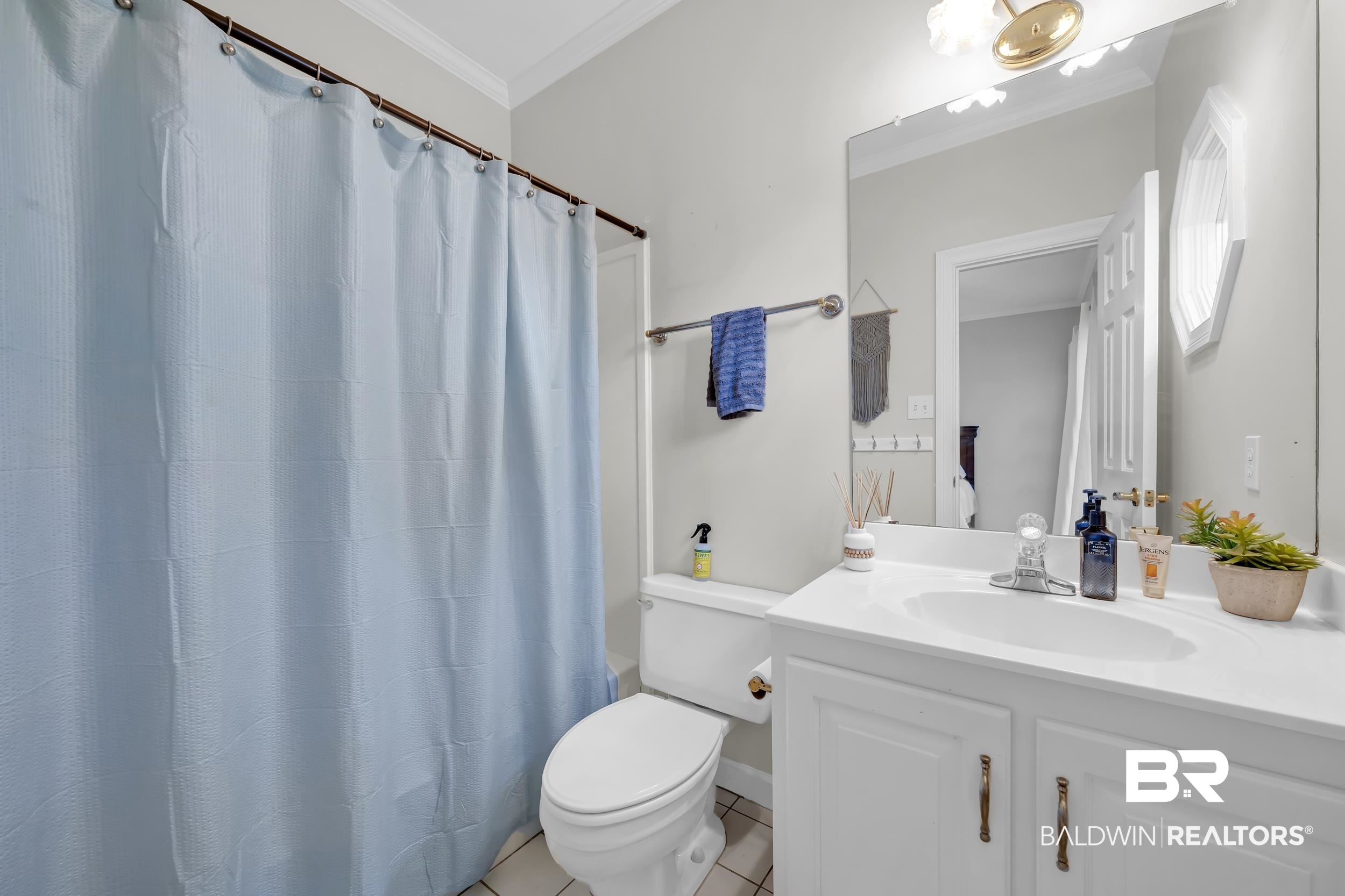 2858 Postoak Circle Mobile, AL 36693 - Photo 23 of 32 Full bath featuring vanity, ornamental molding, shower / bathtub combination with curtain, and light tile patterned floors