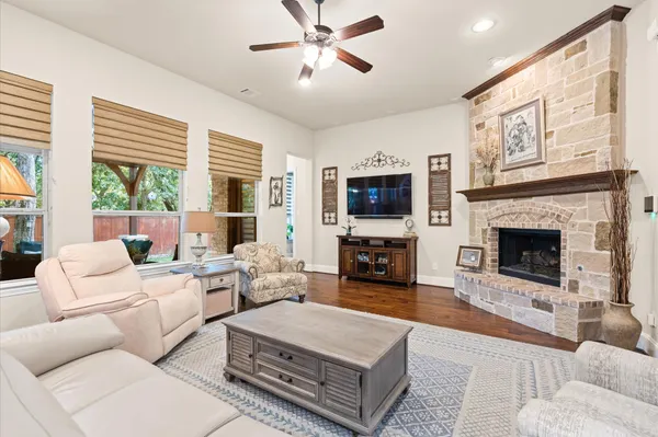a living room with furniture a fireplace and a flat screen tv