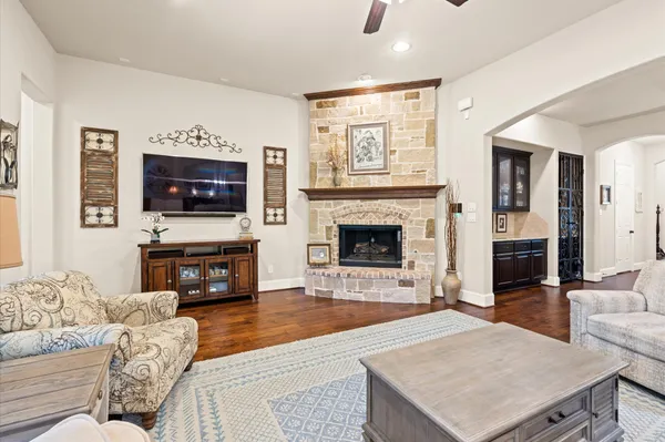 a living room with furniture a fireplace and a flat screen tv