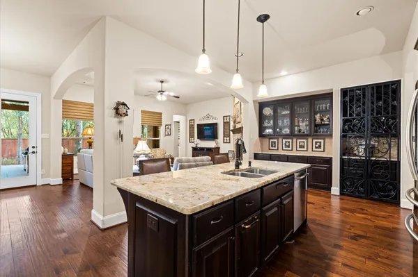 a kitchen with a counter space wooden floor and appliances