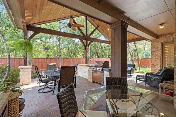 a view of an outdoor dining space with a table chairs and balcony