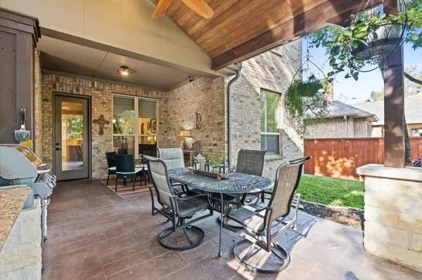 a view of an outdoor dining space with a table and chairs