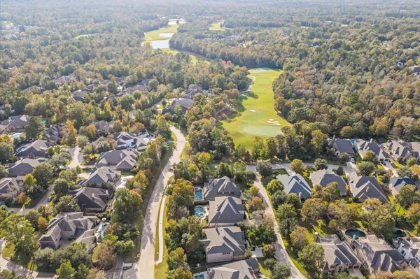 a aerial view of a residential houses with yard