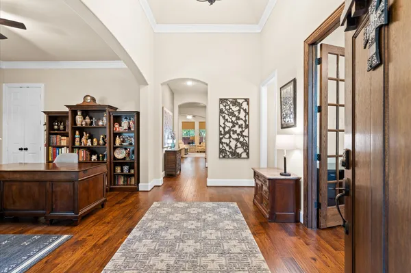 a living room with furniture a rug and a book shelf