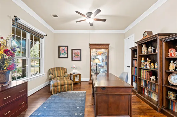 a living room with furniture and a bookshelf
