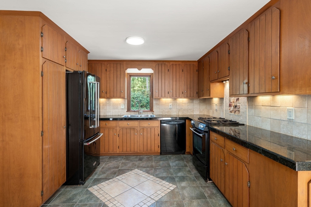 27 Stuart Road Rochester, MA 02770 - Photo 12 of 42 a kitchen with stainless steel appliances granite countertop a refrigerator a sink a stove top oven and a dishwasher