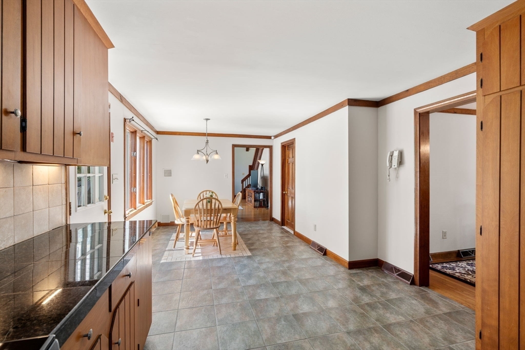 27 Stuart Road Rochester, MA 02770 - Photo 16 of 42 a dining room with furniture and a chandelier