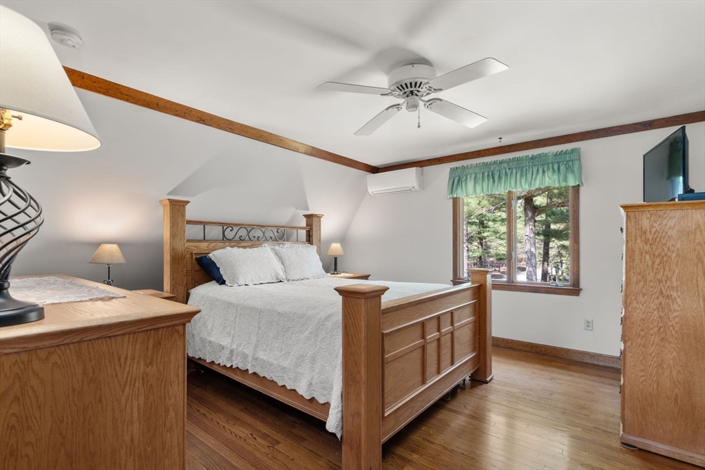 27 Stuart Road Rochester, MA 02770 - Photo 19 of 42 a bedroom with a bed and a chandelier