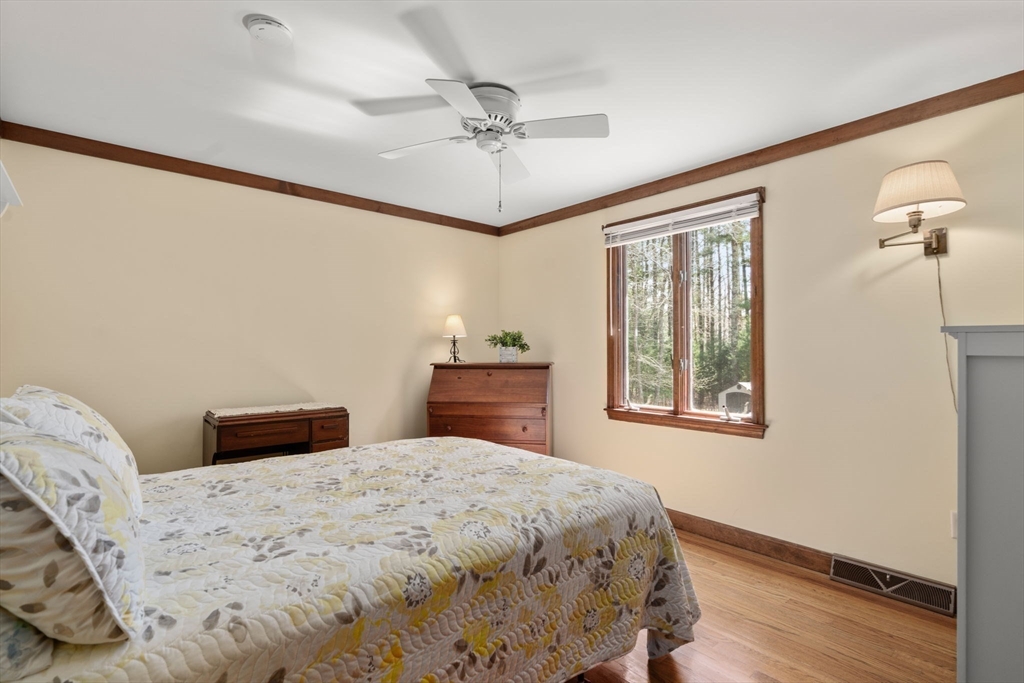 27 Stuart Road Rochester, MA 02770 - Photo 21 of 42 a bedroom with a bed and a chandelier