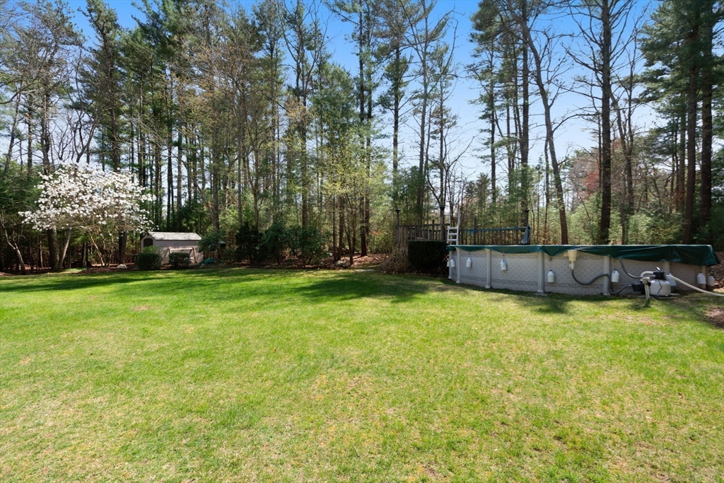 27 Stuart Road Rochester, MA 02770 - Photo 24 of 42 a backyard of a house with lots of green space