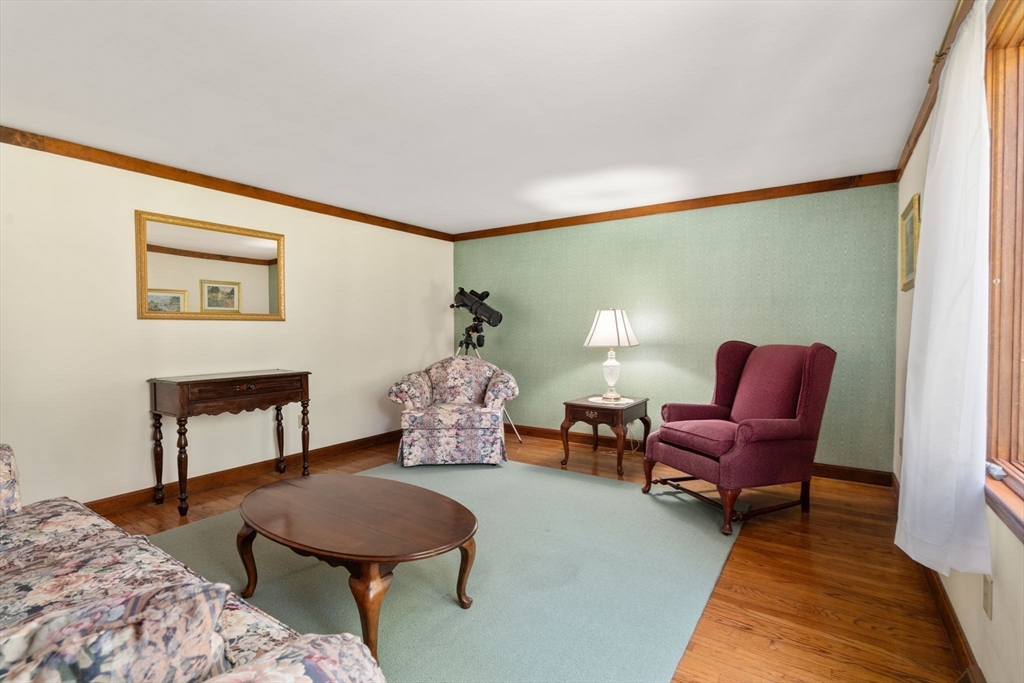 27 Stuart Road Rochester, MA 02770 - Photo 37 of 42 a living room with furniture and a wooden floor