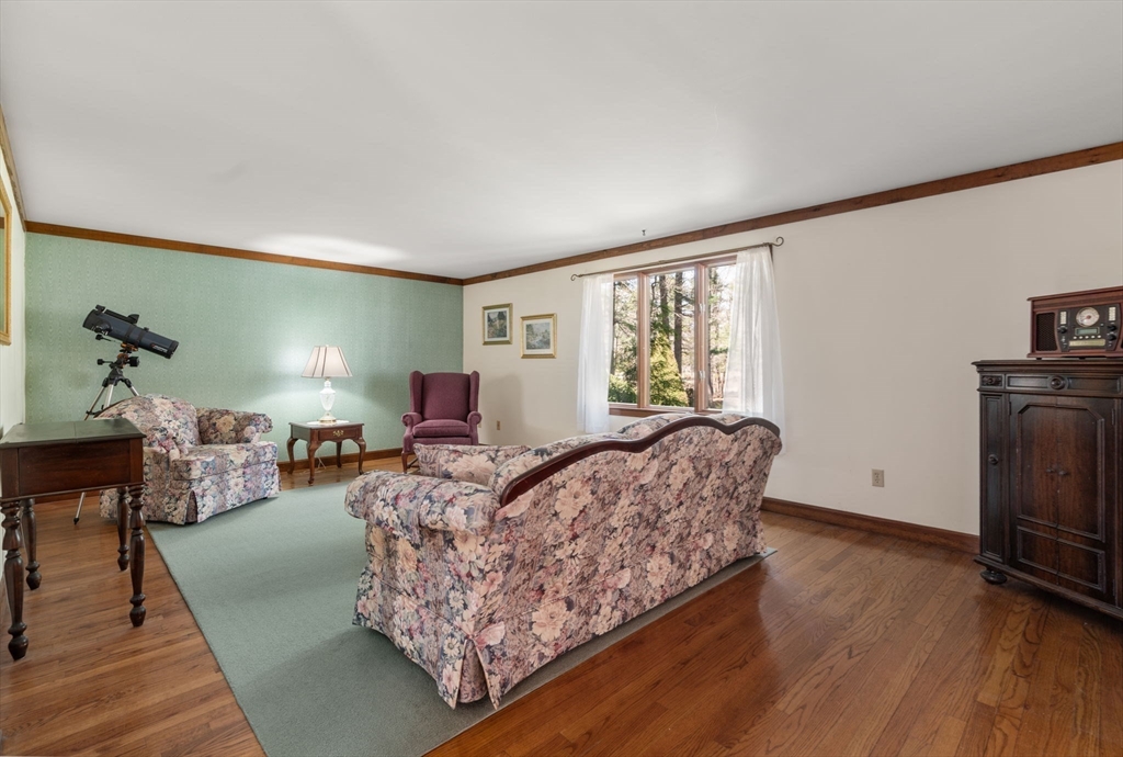 27 Stuart Road Rochester, MA 02770 - Photo 38 of 42 a living room with furniture and a fireplace