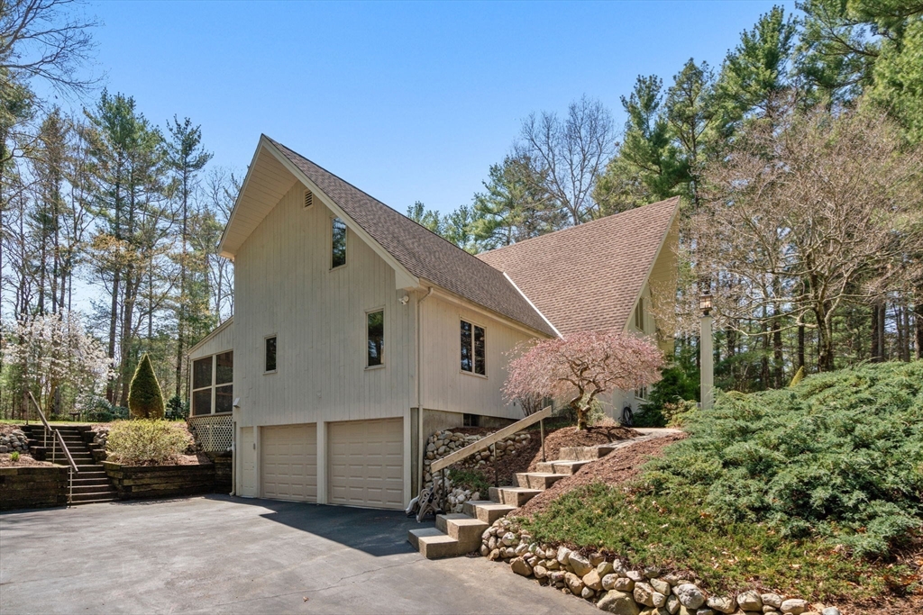 27 Stuart Road Rochester, MA 02770 - Photo 40 of 42 a view of a white house with a yard and garage