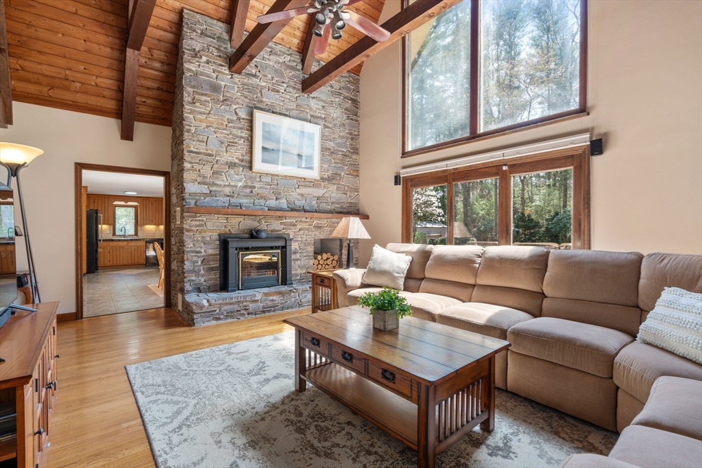 27 Stuart Road Rochester, MA 02770 - Photo 10 of 42 a living room with furniture a fireplace and a large window