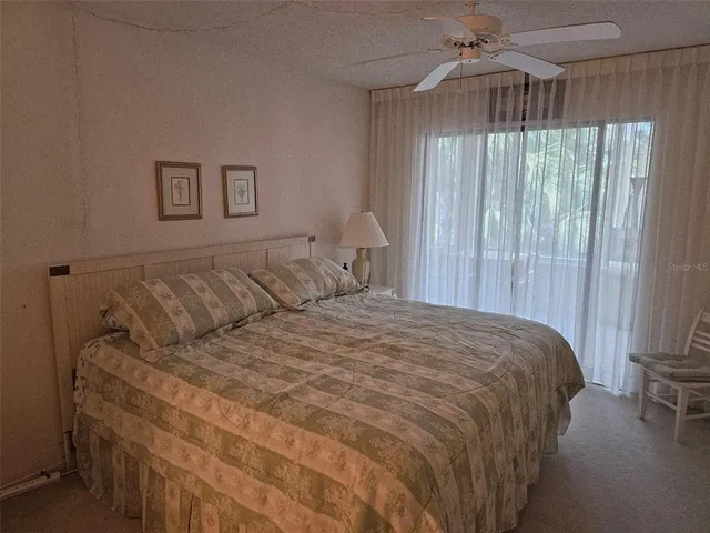 a large bed sitting in a bedroom next to a window