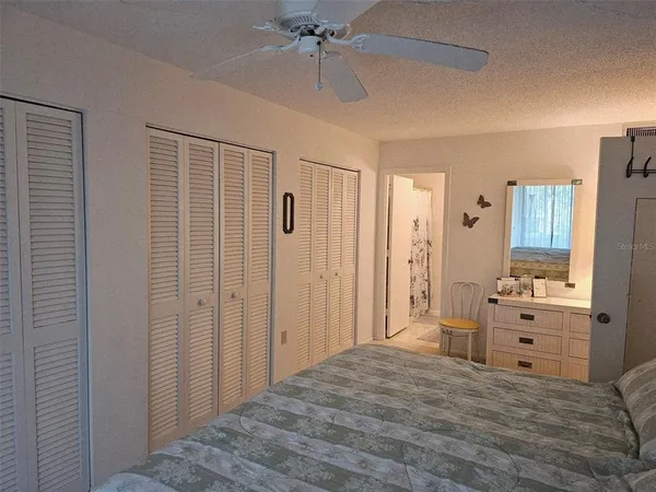 a bedroom with a dresser and a chandelier