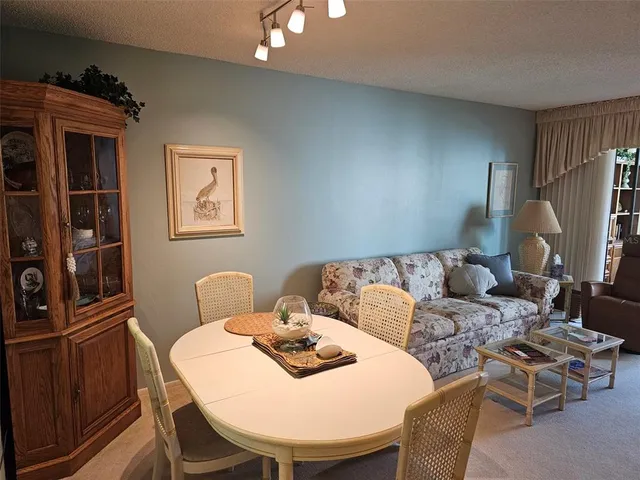 a living room with furniture a lamp and a window