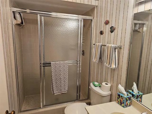 a bathroom with a toilet and a shower