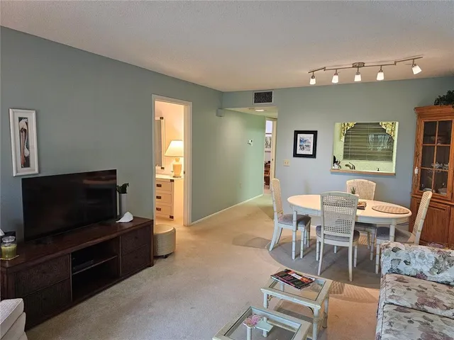 a view of a livingroom with furniture and a flat screen tv