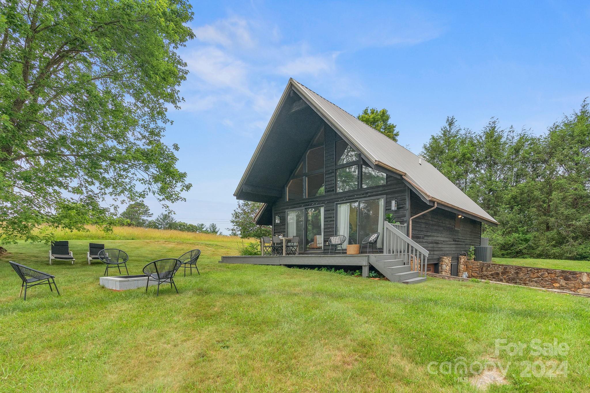 407 Newfound Road Leicester, NC 28748 - Photo 2 of 48 a view of a house with a yard porch and sitting area