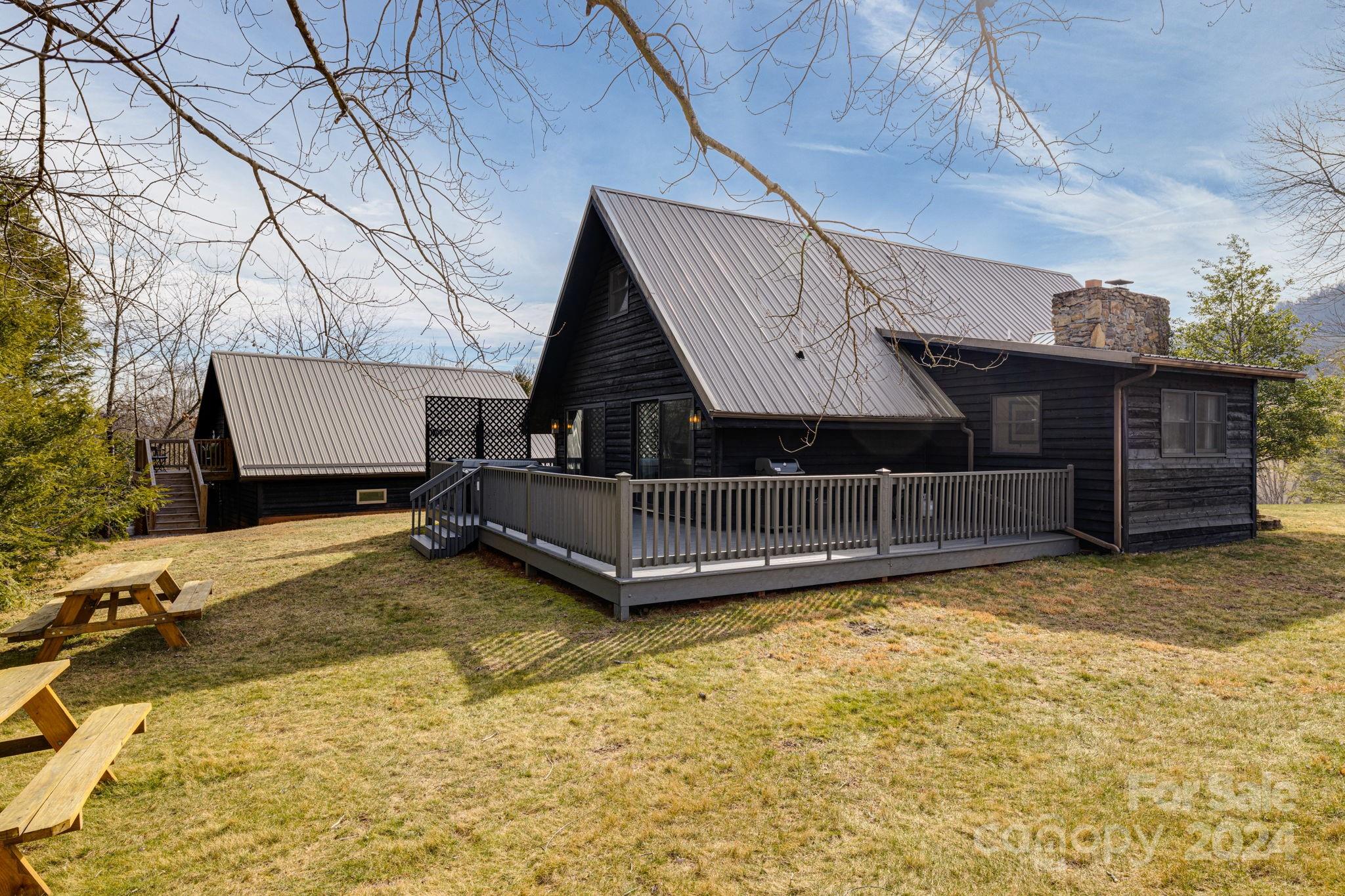 407 Newfound Road Leicester, NC 28748 - Photo 45 of 48 a view of a house with a yard and wooden fence