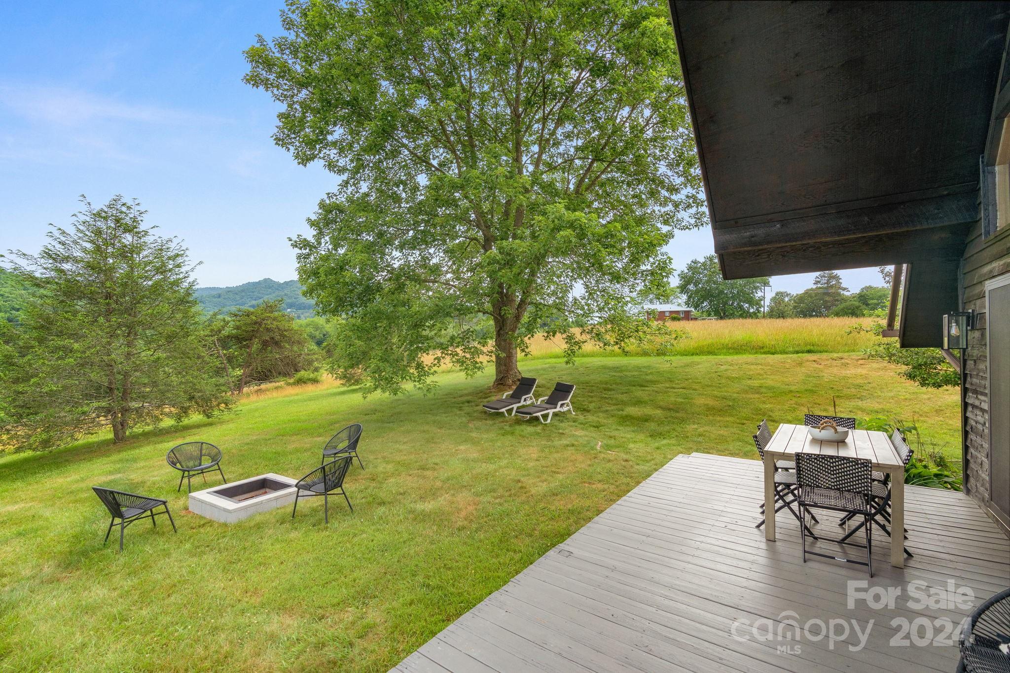 407 Newfound Road Leicester, NC 28748 - Photo 6 of 48 an outdoor space with furniture and garden