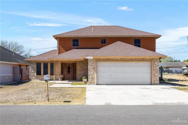 a front view of a house with yard