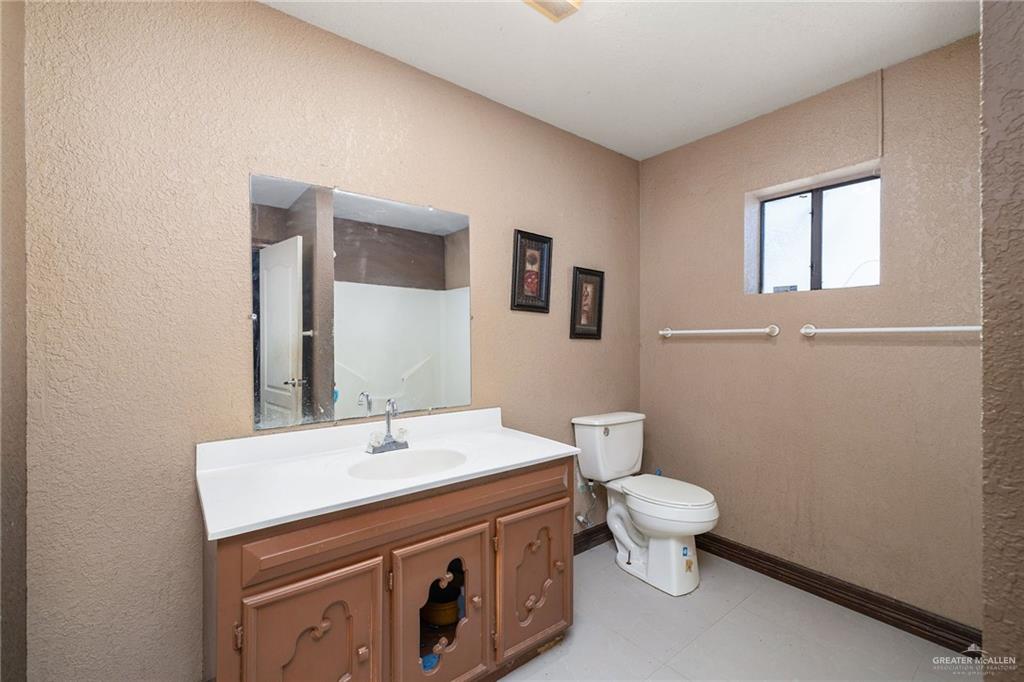 117 Hernandez Road Rio Grande City, TX 78582 - Photo 11 of 23 a bathroom with a toilet sink and mirror
