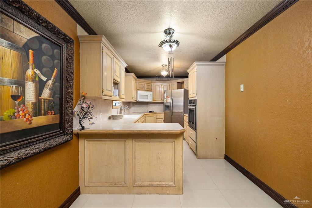 117 Hernandez Road Rio Grande City, TX 78582 - Photo 7 of 23 a view of a kitchen with a sink and cabinet
