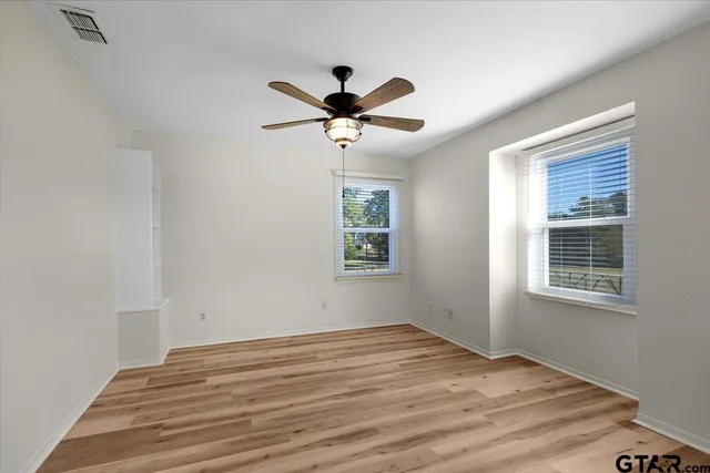 a bathroom with a granite countertop sink toilet and a mirror