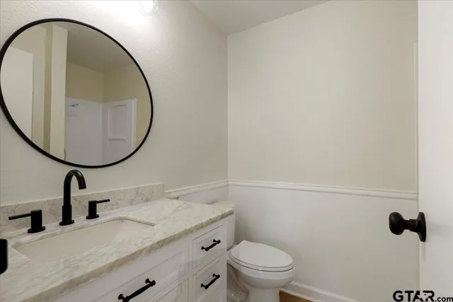 a living room with furniture kitchen view and a chandelier