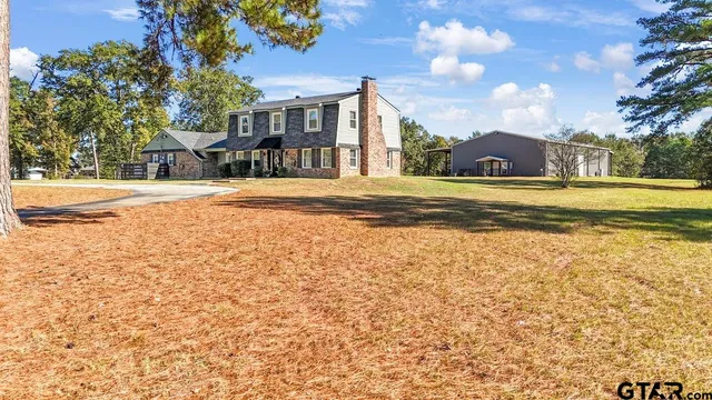 a view of house with yard and green space