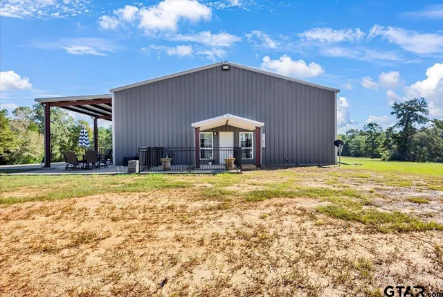 a house view with swimming pool in front of it