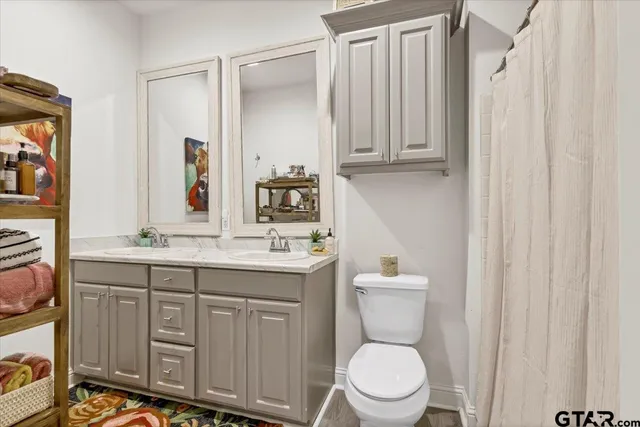 a big yard with table and trees in the background