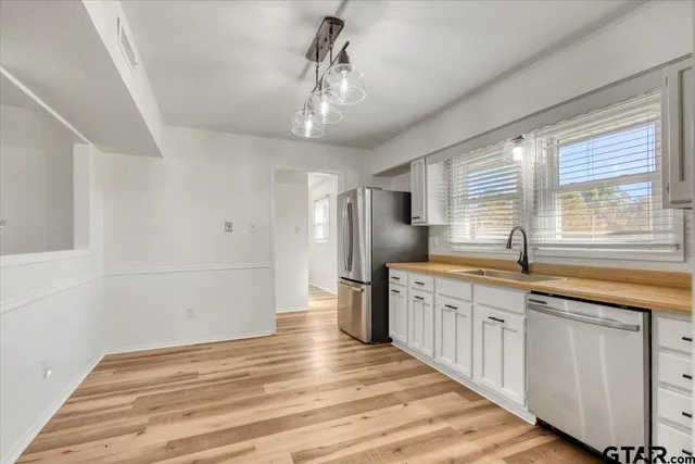 a view of staircase with wooden floor and white walls
