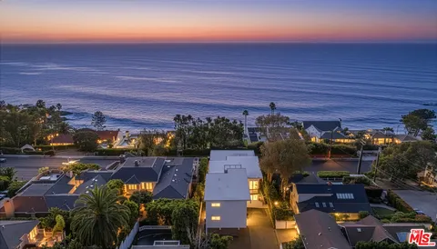 an aerial view of a house with a ocean view