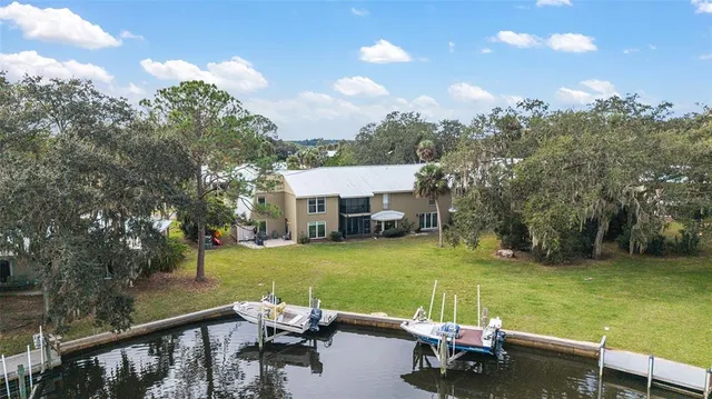 a view of a patio with table and chairs with wooden floor and fence