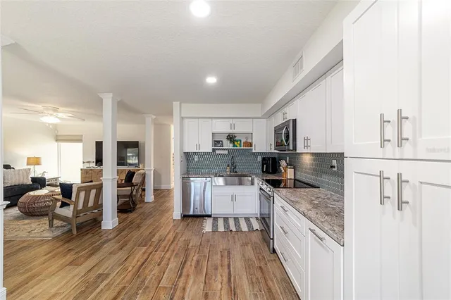 a kitchen with counter top space a stove a refrigerator and cabinets