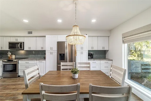 a kitchen with sink refrigerator and microwave