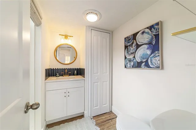 a bathroom with a toilet a sink and a mirror