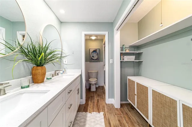 a spacious bathroom with a granite countertop sink and a mirror