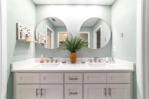 a bathroom with double vanity sinks and a