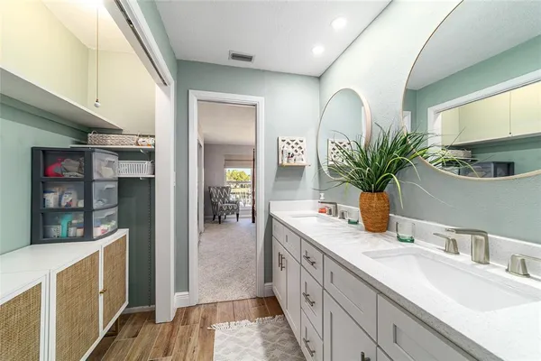 a spacious bathroom with a granite countertop sink a mirror and shower