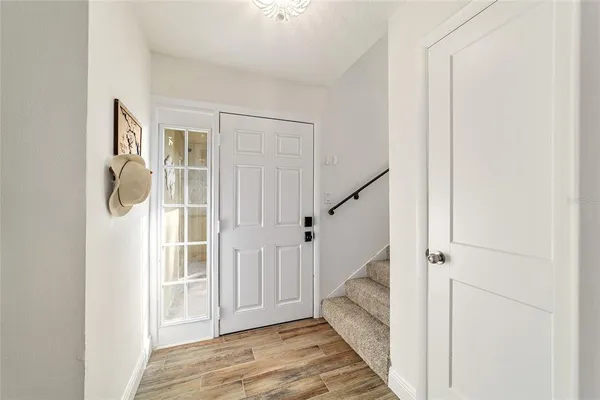 a view of entryway with wooden floor and stairs