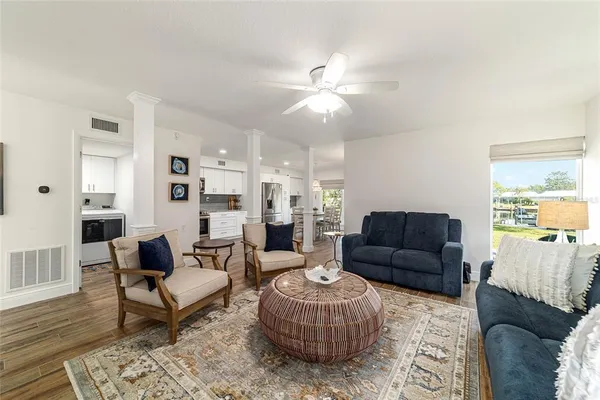 a living room with furniture and wooden floor