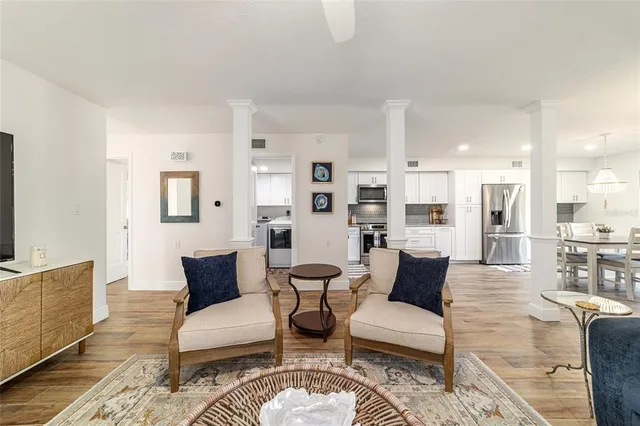 a living room with furniture wooden floor and a flat screen tv
